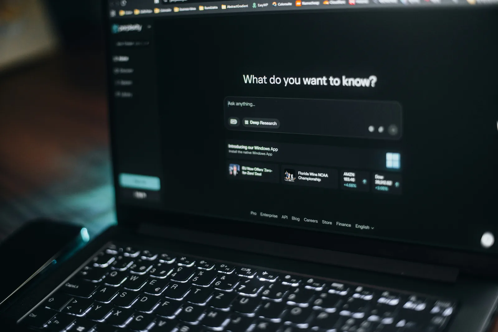 User typing into an AI search interface on a laptop, symbolizing modern search behavior and best practices on How to Rank in AI Search covered in the LLM Guide.