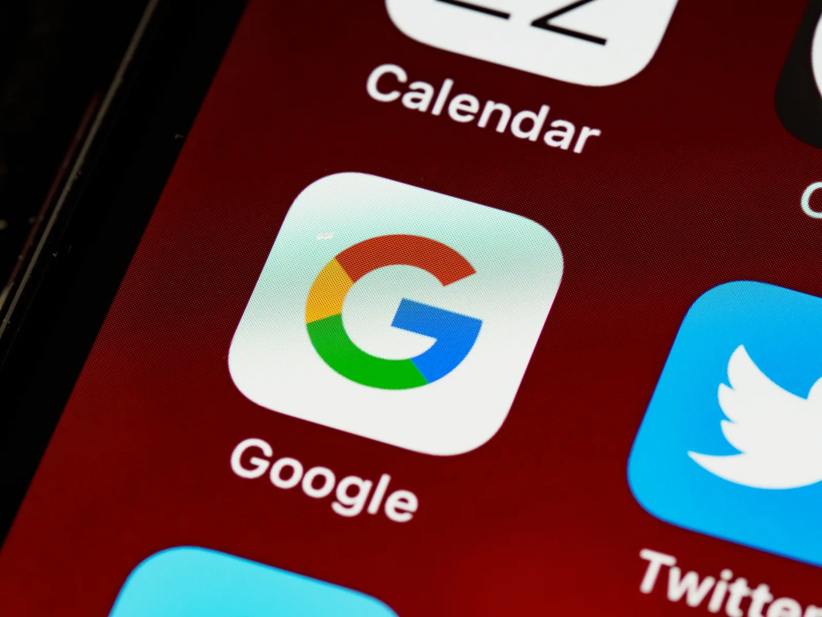 Close-up of the Google app icon on a smartphone screen, representing Google’s role in AI and search technology.