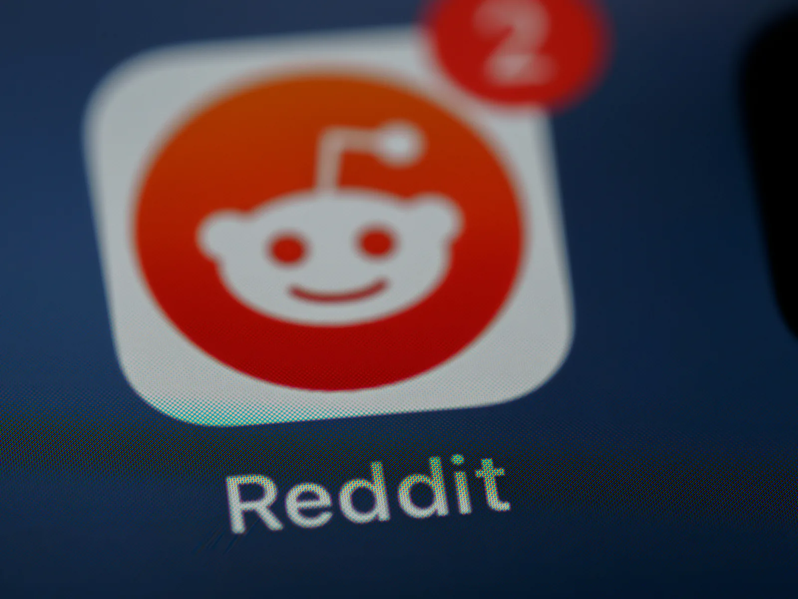 Close-up of the Reddit app icon representing how OpenAI partnerships pull real-time Reddit data into ChatGPT answers, highlighting the importance of AI visibility and generative engine optimisation for brands aiming to recover traffic lost to AI.