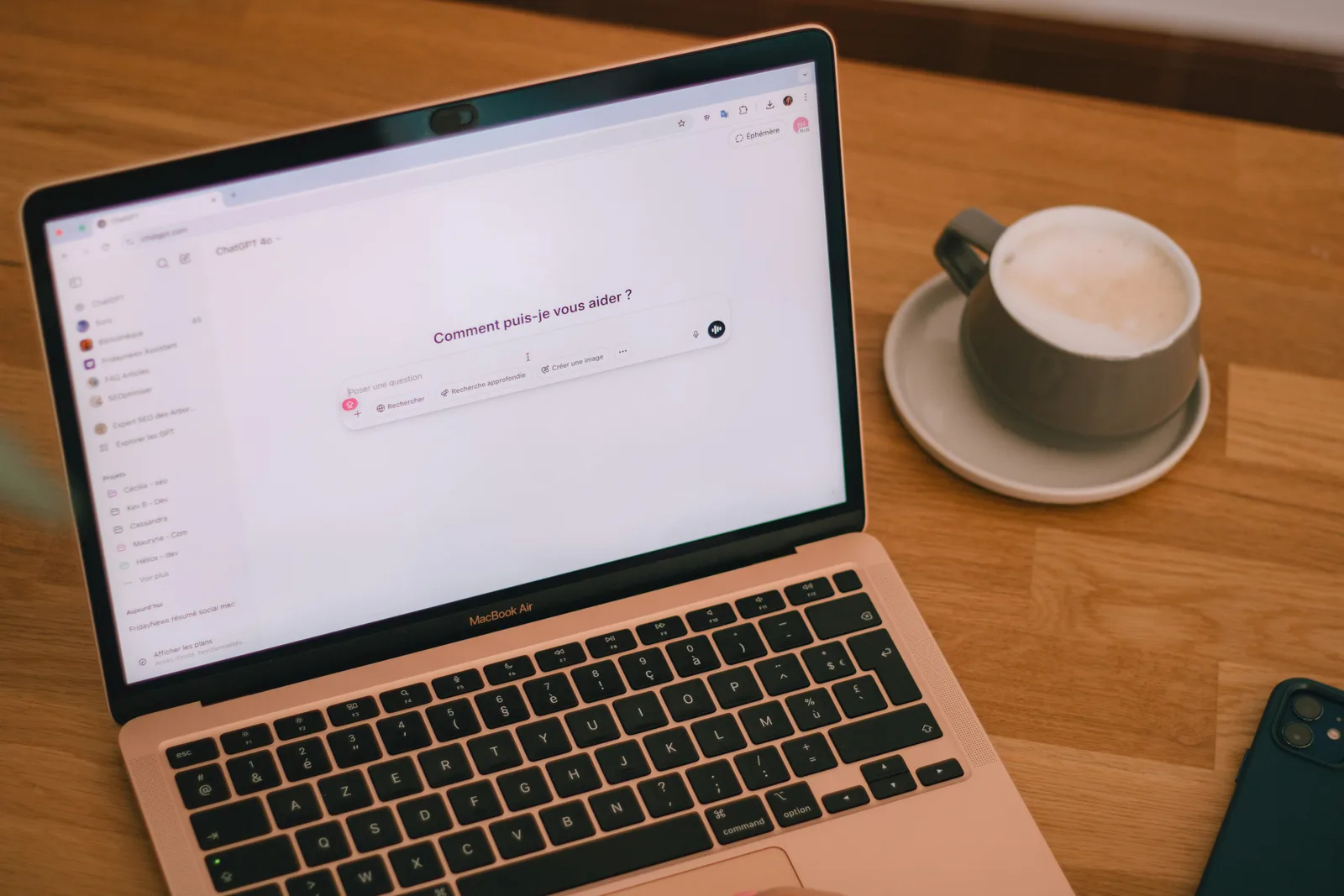 A laptop on a wooden table showing the ChatGPT interface, representing how brands appear in AI answers and why AI Visibility optimisation is essential for staying visible on ChatGPT vs present in its training data.