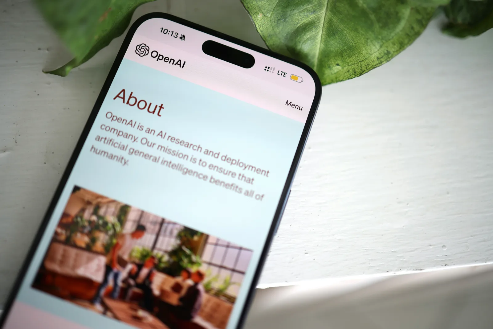 OpenAI About page shown on a smartphone screen, highlighting the company’s mission in artificial intelligence.